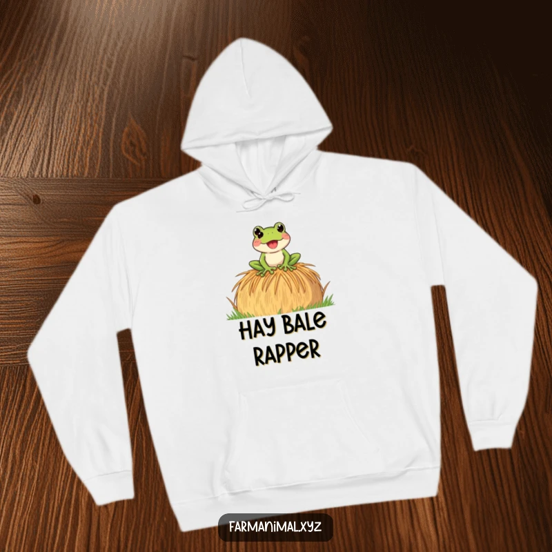 Funny Frog Hoodie showing a playful frog croaking loudly on a hay bale, offering warmth and a touch of humorous farmyard sound.