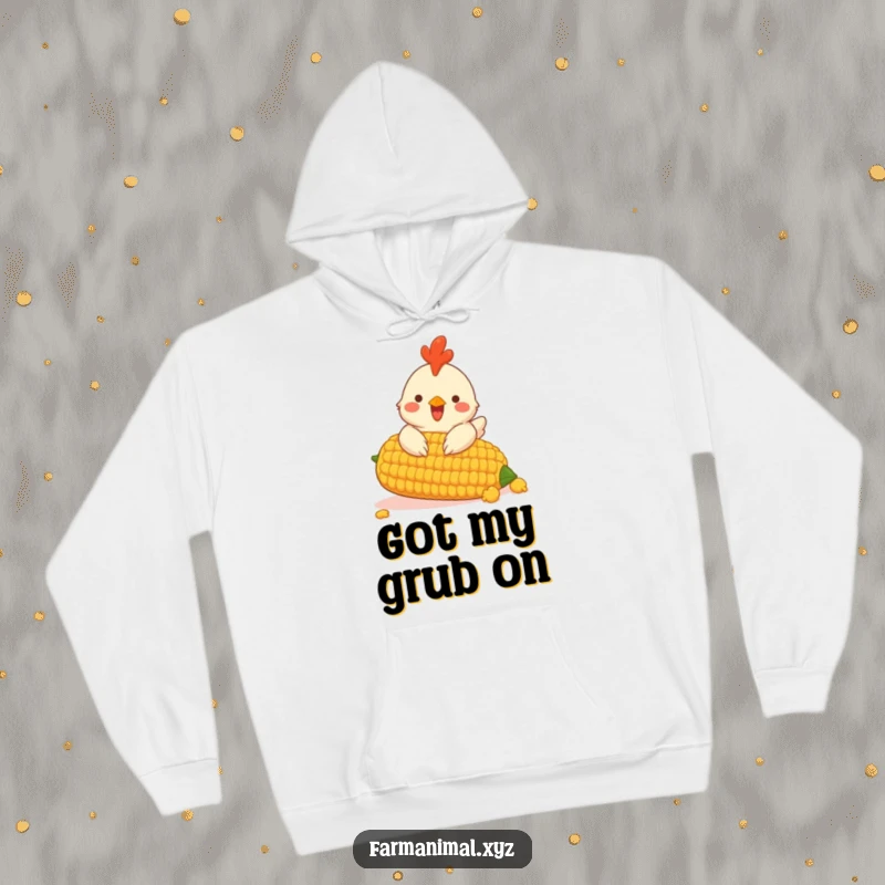 Funny hoodie featuring a cheerful chicken pecking at a giant corn cob, perfect for cozy farm fun.